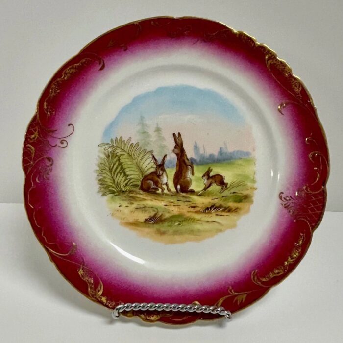 Decorative plate with rabbits and landscape design.